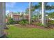 Charming home with lush landscaping, palm trees, and a well-manicured lawn at 107 Nippino W Trl, Nokomis, FL 34275