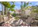 Cozy front yard with outdoor seating area and charming walkway to the entrance at 107 Nippino W Trl, Nokomis, FL 34275
