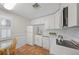 Clean kitchen with white cabinets, stainless steel appliances, and tile flooring at 107 Nippino W Trl, Nokomis, FL 34275