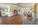 Open living area with wood floors, decorative furniture, and a view into the dining area at 107 Nippino W Trl, Nokomis, FL 34275