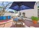 A cozy patio with a dining table, seating, and landscaping at 107 Nippino W Trl, Nokomis, FL 34275