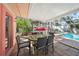 Screened-in patio with dining set overlooking the pool area at 107 Nippino W Trl, Nokomis, FL 34275