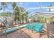 Beautiful screened-in pool with diving board and brick paver surround at 107 Nippino W Trl, Nokomis, FL 34275