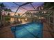 Evening view of the pool and patio area featuring a screened enclosure at 107 Nippino W Trl, Nokomis, FL 34275