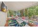 A cozy sun room with seating, a vibrant rug, and views of the outdoors at 107 Nippino W Trl, Nokomis, FL 34275