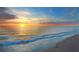 Serene beach view at sunset, with golden light reflecting on the gentle waves at 107 Nippino W Trl, Nokomis, FL 34275