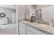 This bathroom features a double sink vanity with a stone countertop, and neutral wall paint at 10713 Tippecanoe Pl, Parrish, FL 34219