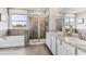 This bathroom features a soaking tub, a glass enclosed shower, and a double sink vanity at 10713 Tippecanoe Pl, Parrish, FL 34219