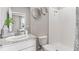 This bathroom features a vanity with stone counters, a white toilet, and walk-in shower at 10713 Tippecanoe Pl, Parrish, FL 34219