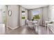 A dining room with tile floor, a white table, four white chairs, and multiple windows at 10713 Tippecanoe Pl, Parrish, FL 34219