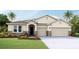 Charming single Gathering home featuring a three car garage and manicured lawn at 10713 Tippecanoe Pl, Parrish, FL 34219
