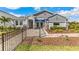 Beautiful single Gathering home with landscaped front yard, inviting entryway and black metal fence at 10713 Tippecanoe Pl, Parrish, FL 34219