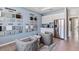 A flex room with gray chairs, tile floors, cabinet and stone samples, and stainless steel appliances at 10713 Tippecanoe Pl, Parrish, FL 34219