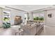 Open-concept living room featuring a large sectional sofa, natural light and modern decor at 10713 Tippecanoe Pl, Parrish, FL 34219