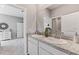 A light and bright bathroom with double sinks, granite countertops, and a door to the toilet and shower area at 10717 Tippecanoe Pl, Parrish, FL 34219