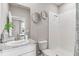 A modern bathroom with a white vanity, granite countertop, and a walk-in shower at 10717 Tippecanoe Pl, Parrish, FL 34219