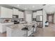 Modern kitchen featuring white cabinets, granite countertops, stainless steel appliances, and bar seating at 10717 Tippecanoe Pl, Parrish, FL 34219