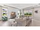 Bright and spacious living room featuring large windows, modern furnishings, and neutral color palette at 10717 Tippecanoe Pl, Parrish, FL 34219