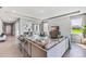 Expansive living room with an open layout leading to the dining area and modern decor at 10717 Tippecanoe Pl, Parrish, FL 34219