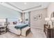 A charming main bedroom featuring a patterned headboard, bench, two windows and an area rug at 10717 Tippecanoe Pl, Parrish, FL 34219