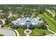 Overhead view of the community pool and amenity center, surrounded by lush landscaping and greenery at 11021 Blue Magnolia Ln, Parrish, FL 34219