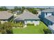 Well-manicured backyard featuring a screened-in porch and lush green lawn at 11021 Blue Magnolia Ln, Parrish, FL 34219