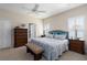 Comfortable bedroom with neutral tones, plantation shutters, and coordinated furniture at 11021 Blue Magnolia Ln, Parrish, FL 34219