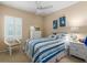 Serene bedroom with a coastal theme, showcasing bright decor and shuttered window at 11021 Blue Magnolia Ln, Parrish, FL 34219