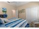 Charming bedroom featuring coastal-themed decor, a striped comforter, and ample closet space at 11021 Blue Magnolia Ln, Parrish, FL 34219