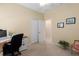 Cozy bedroom featuring neutral walls and flooring, closet space, and a dedicated desk area at 11021 Blue Magnolia Ln, Parrish, FL 34219