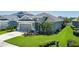 Beautiful single-story home with a gray exterior, lush landscaping, and a two-car garage at 11021 Blue Magnolia Ln, Parrish, FL 34219