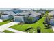 Charming single-story home with an attached garage and a well-maintained lawn with tropical landscaping at 11021 Blue Magnolia Ln, Parrish, FL 34219