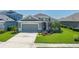 Well-maintained single-story home with lush green lawn and inviting curb appeal at 11021 Blue Magnolia Ln, Parrish, FL 34219