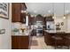 Gourmet kitchen with dark wood cabinetry, granite counters, and a stainless steel refrigerator at 11021 Blue Magnolia Ln, Parrish, FL 34219
