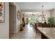 Open-concept living room with tile flooring and comfortable seating, leading to a screened lanai at 11021 Blue Magnolia Ln, Parrish, FL 34219