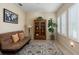 Cozy living area with tiled flooring, a comfortable sofa, a bookcase, and ample natural light from large windows at 11021 Blue Magnolia Ln, Parrish, FL 34219