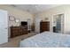 Spacious main bedroom featuring wood furniture, a large bed, and an ensuite bathroom at 11021 Blue Magnolia Ln, Parrish, FL 34219