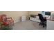 Home office with carpet floors, large desk, and a floral chair at 11021 Blue Magnolia Ln, Parrish, FL 34219