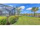 Expansive backyard showcasing lush greenery, a tranquil lake, and a beautiful property in a peaceful setting at 11176 Roseate Ct, Sarasota, FL 34238