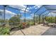 Serene backyard featuring a beautifully landscaped yard, a calm lake, and an inviting screened lanai area at 11176 Roseate Ct, Sarasota, FL 34238