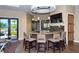 Stylish bar area with seating, modern lighting, and a TV for entertainment at 11176 Roseate Ct, Sarasota, FL 34238