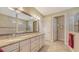 Elegant bathroom with a large mirror, double sinks, granite countertop, and tile flooring at 11176 Roseate Ct, Sarasota, FL 34238