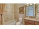 Neutral-toned bathroom featuring a bathtub and shower combo, toilet, and vanity at 11176 Roseate Ct, Sarasota, FL 34238