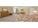 Inviting bedroom featuring bright yellow walls, natural light, and a cozy quilt on the bed at 11176 Roseate Ct, Sarasota, FL 34238