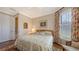 Bedroom featuring a patterned comforter, elegant window, and neutral walls at 11176 Roseate Ct, Sarasota, FL 34238