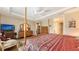 Four-poster bedroom with a tray ceiling and access to additional rooms at 11176 Roseate Ct, Sarasota, FL 34238