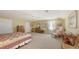 Inviting bedroom with a quilt-covered bed, dresser, and a cozy seating area at 11176 Roseate Ct, Sarasota, FL 34238