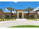 Elegant clubhouse entrance featuring a covered entryway, stone accents, and manicured landscaping at 11176 Roseate Ct, Sarasota, FL 34238