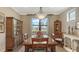 Dining room with hardwood floors, large window with water view, chandelier, and two built-in cabinets at 11176 Roseate Ct, Sarasota, FL 34238
