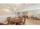 Cozy dining area featuring a wooden table, comfortable chairs, and a decorative Tiffany-style lamp at 11176 Roseate Ct, Sarasota, FL 34238